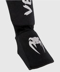 VENUM-0480-128 KONTACT ELASTIC MUAY THAI BOXING MMA SHIN GUARD PROTECTOR Baumwolle Größe ML Schwarz Silber